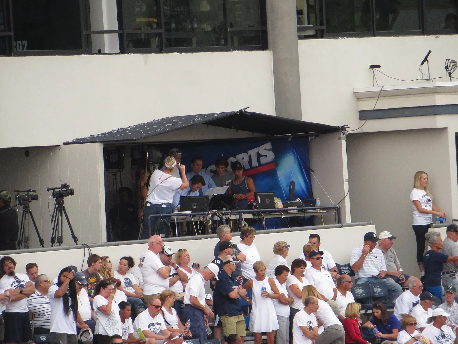 A CBS Sports broadcast booth at a college football stadium