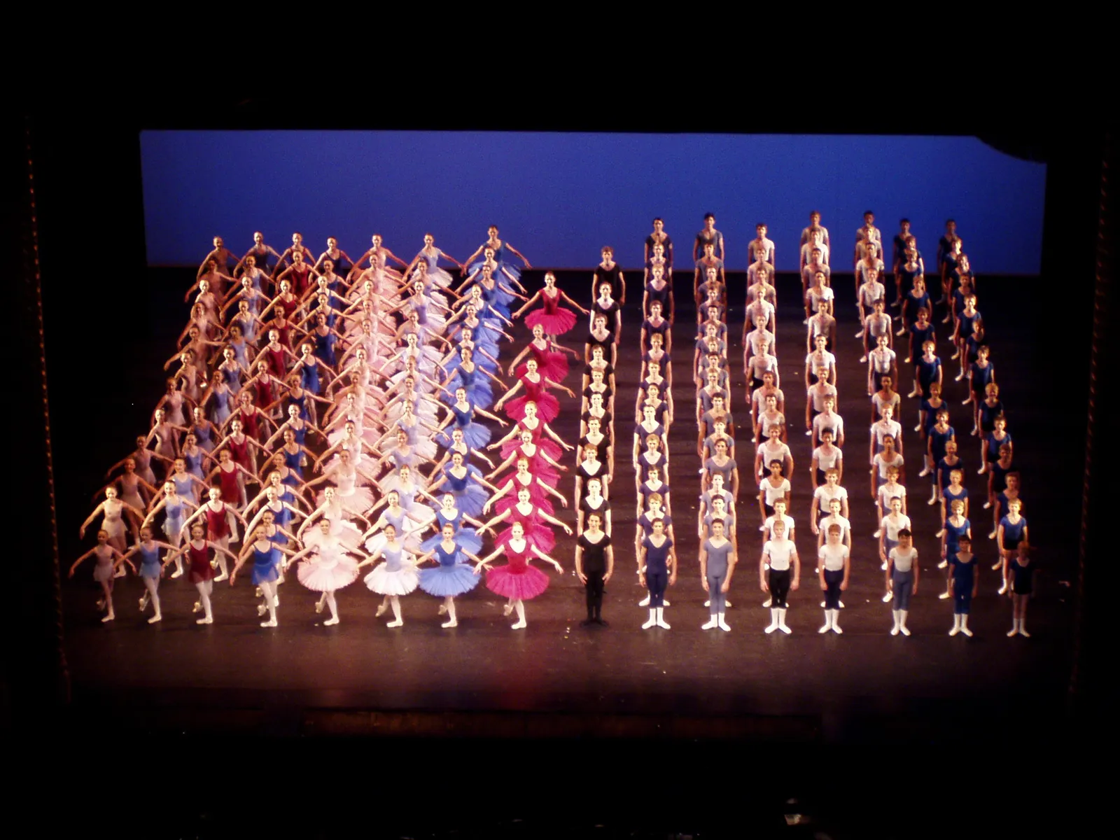 Dancers take a curtain call on stage.