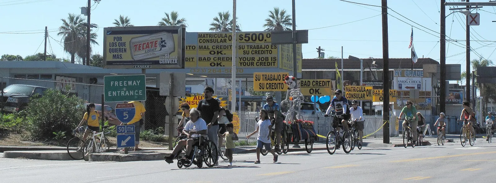 Cyclists and pedestrians fill a car-free street during a CicLAvia event.