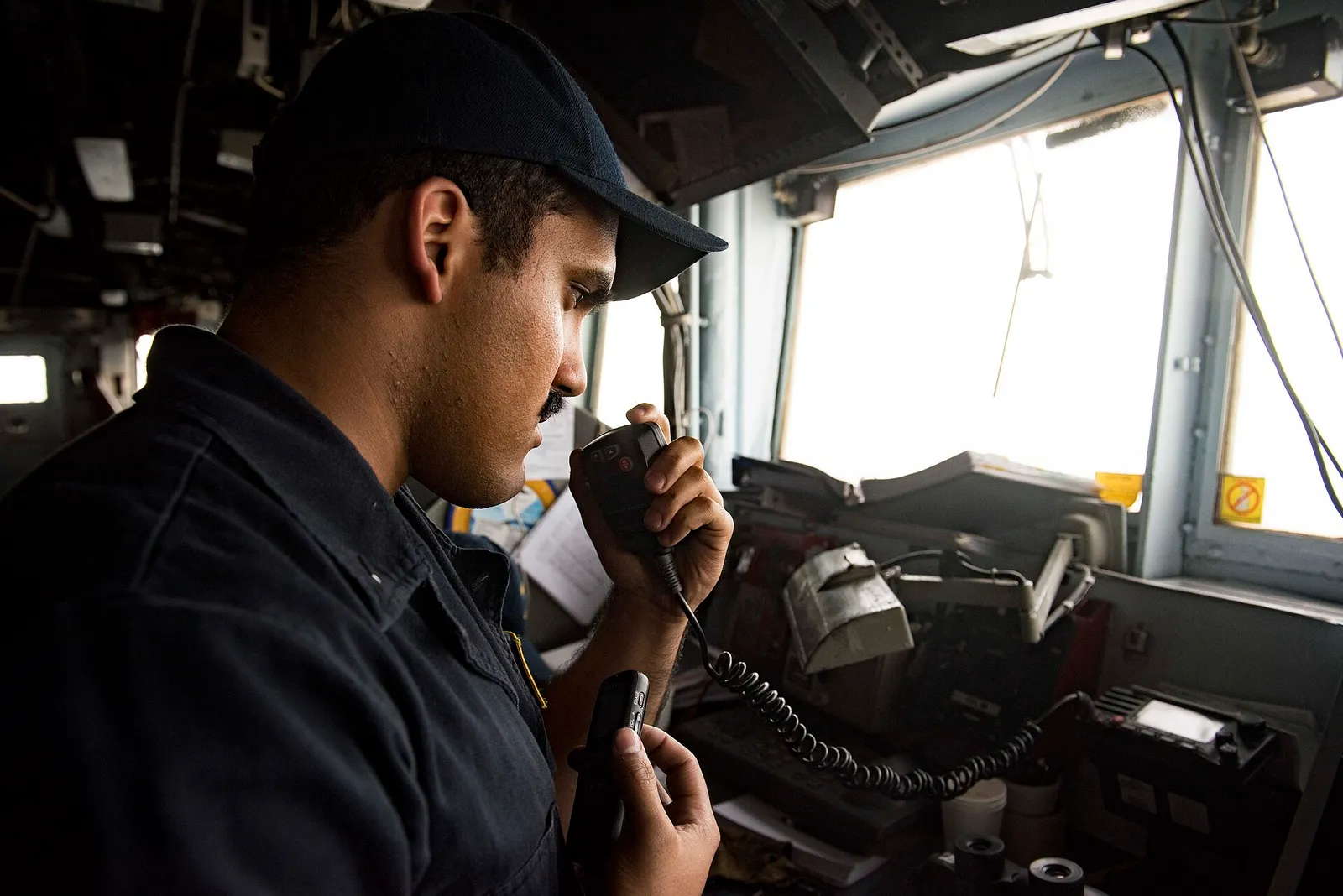 A U.S. Navy sailor stands watch aboard a warship in the Strait of Hormuz.