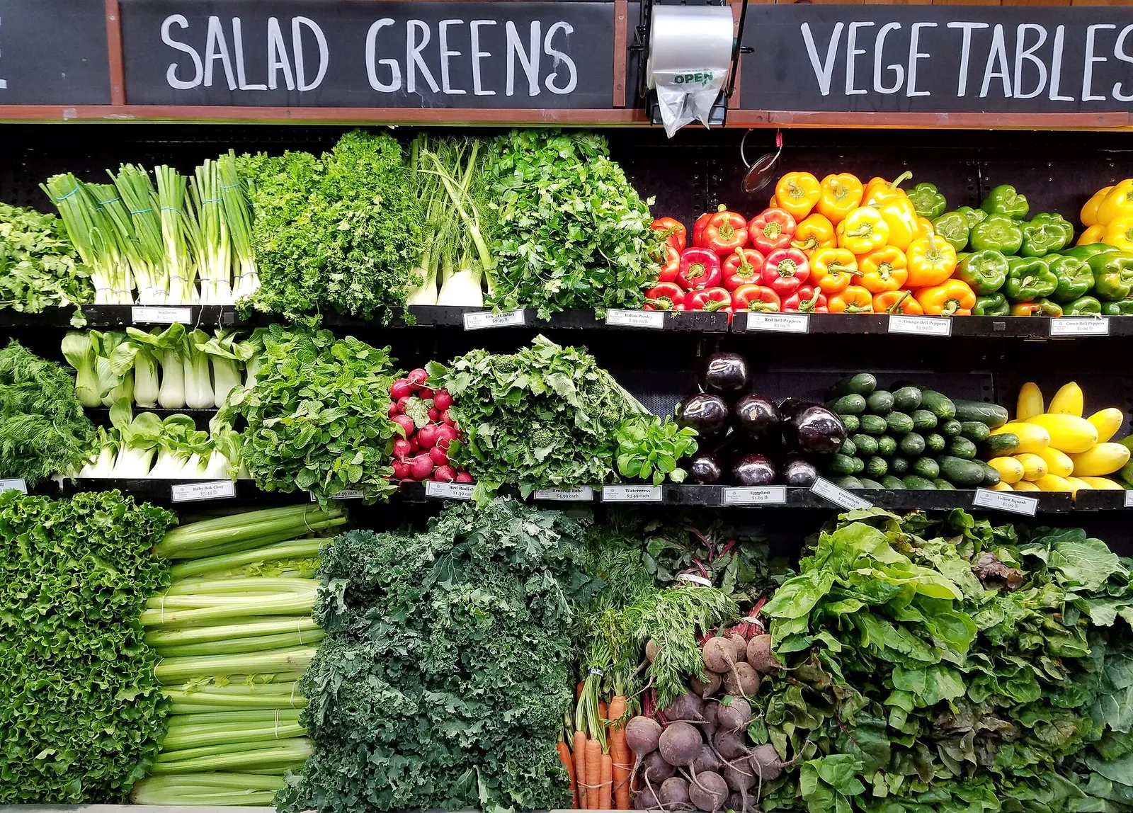 Fresh salad greens and vegetables on display.