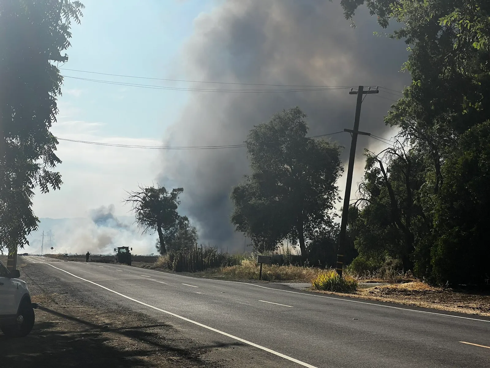 A heavy plume of smoke rises from a warehouse fire.