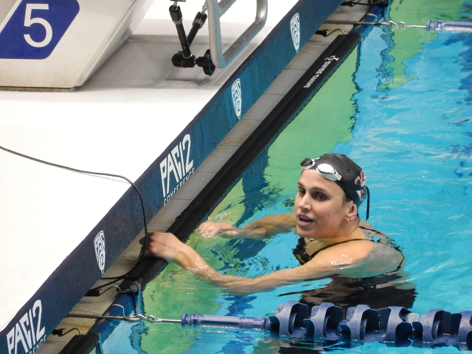 A swimmer competing in a freestyle race.