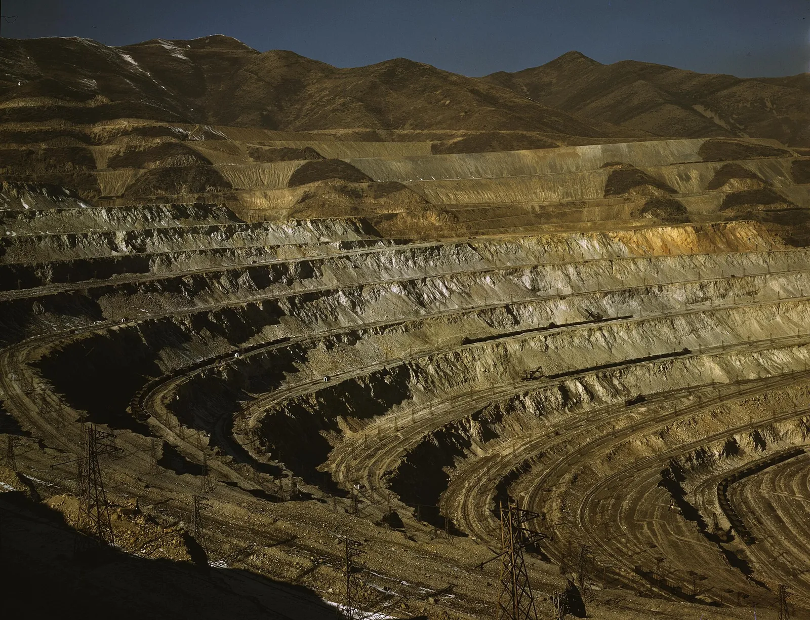A large open-pit mine (Bingham Canyon, Utah), shown as an illustration of hard-rock mining; the Sangdong tungsten mine is an underground operation.