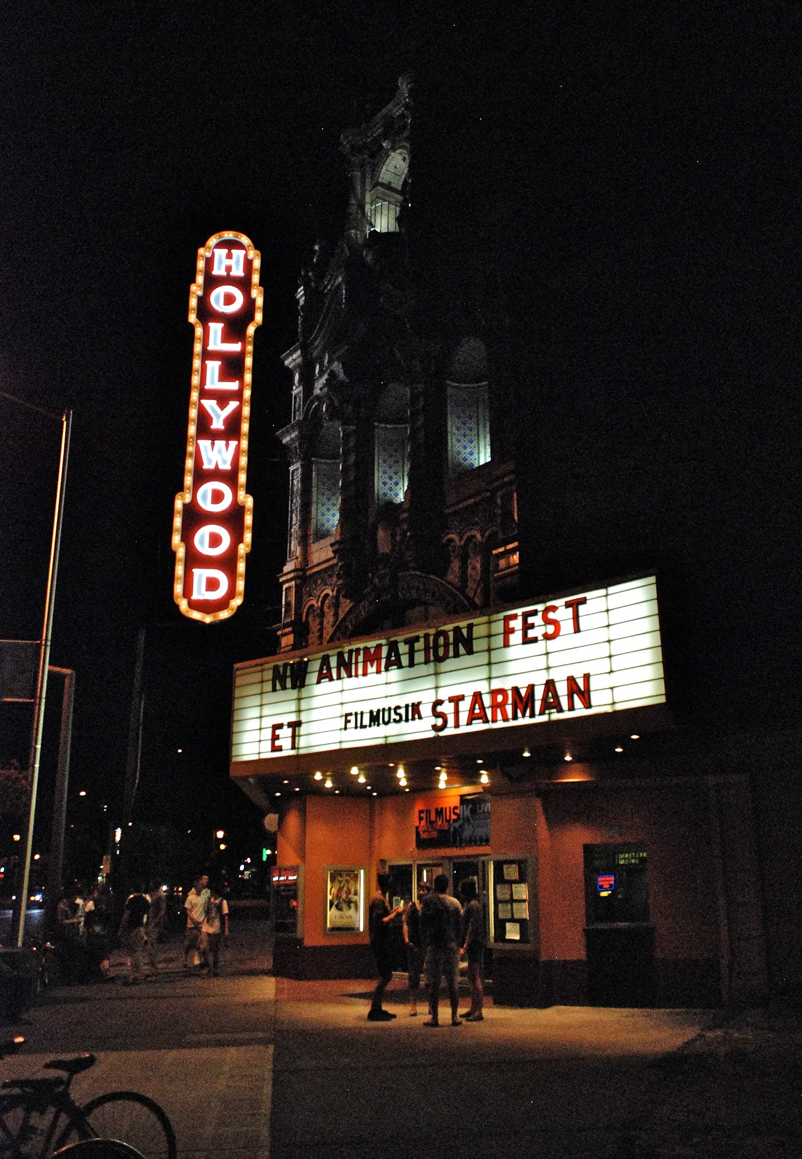 A movie theater marquee lit up at night.