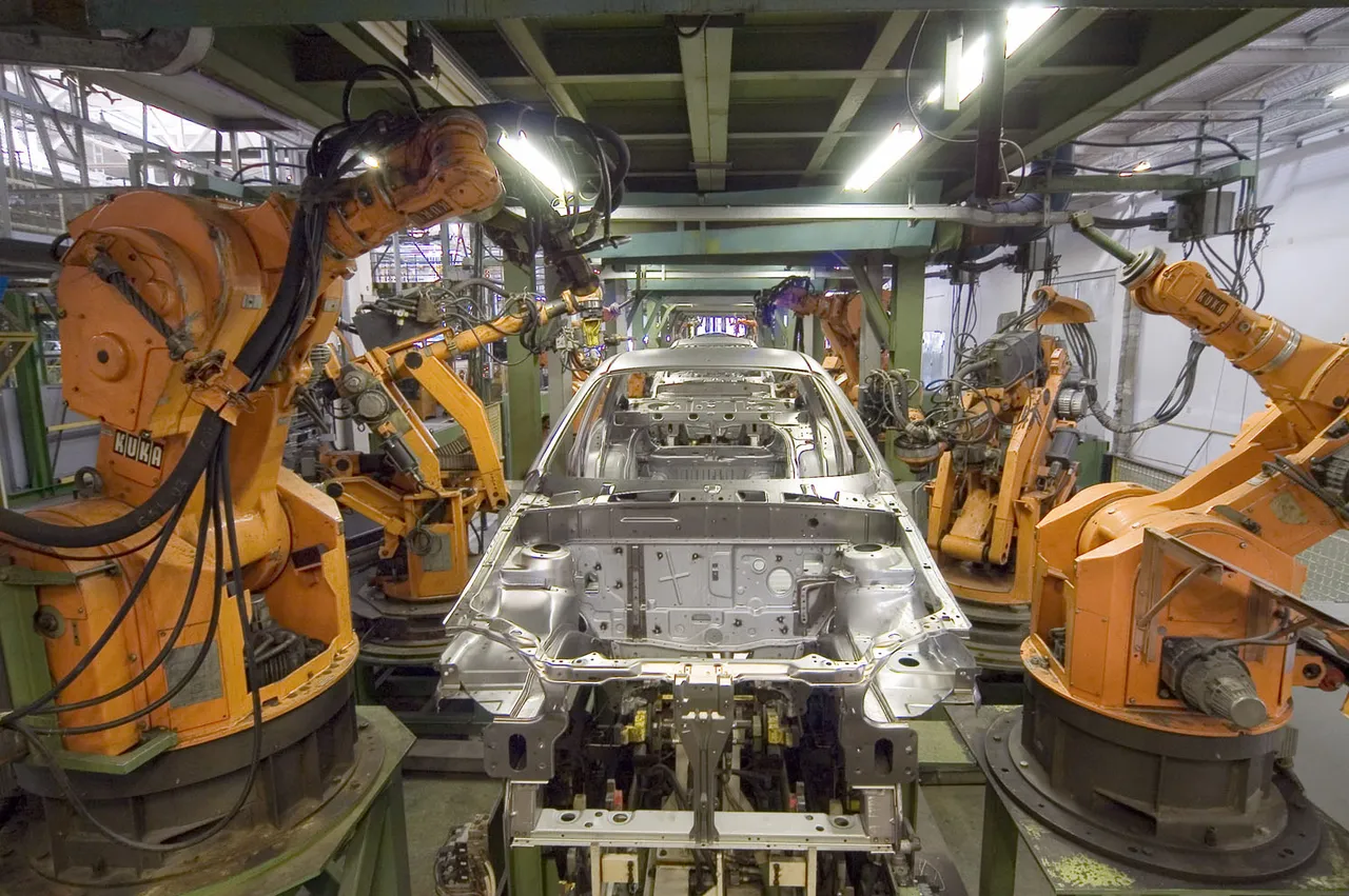 Industrial robot arms on a factory line.