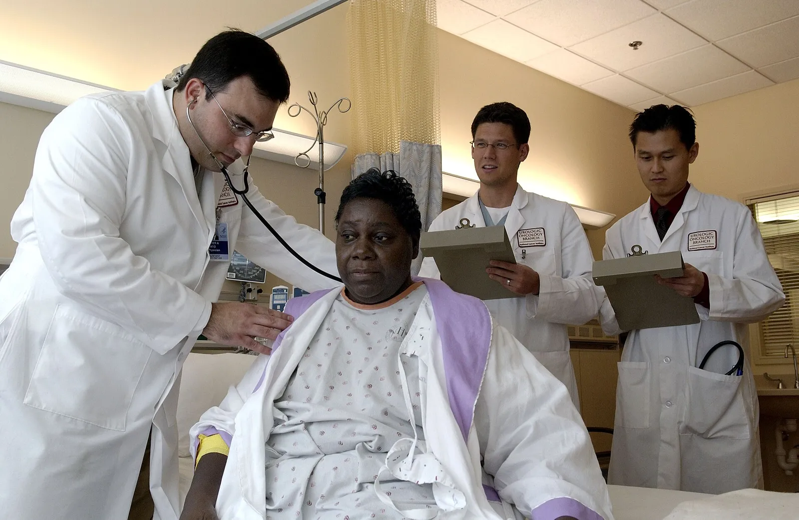 A doctor examines a patient with a stethoscope.
