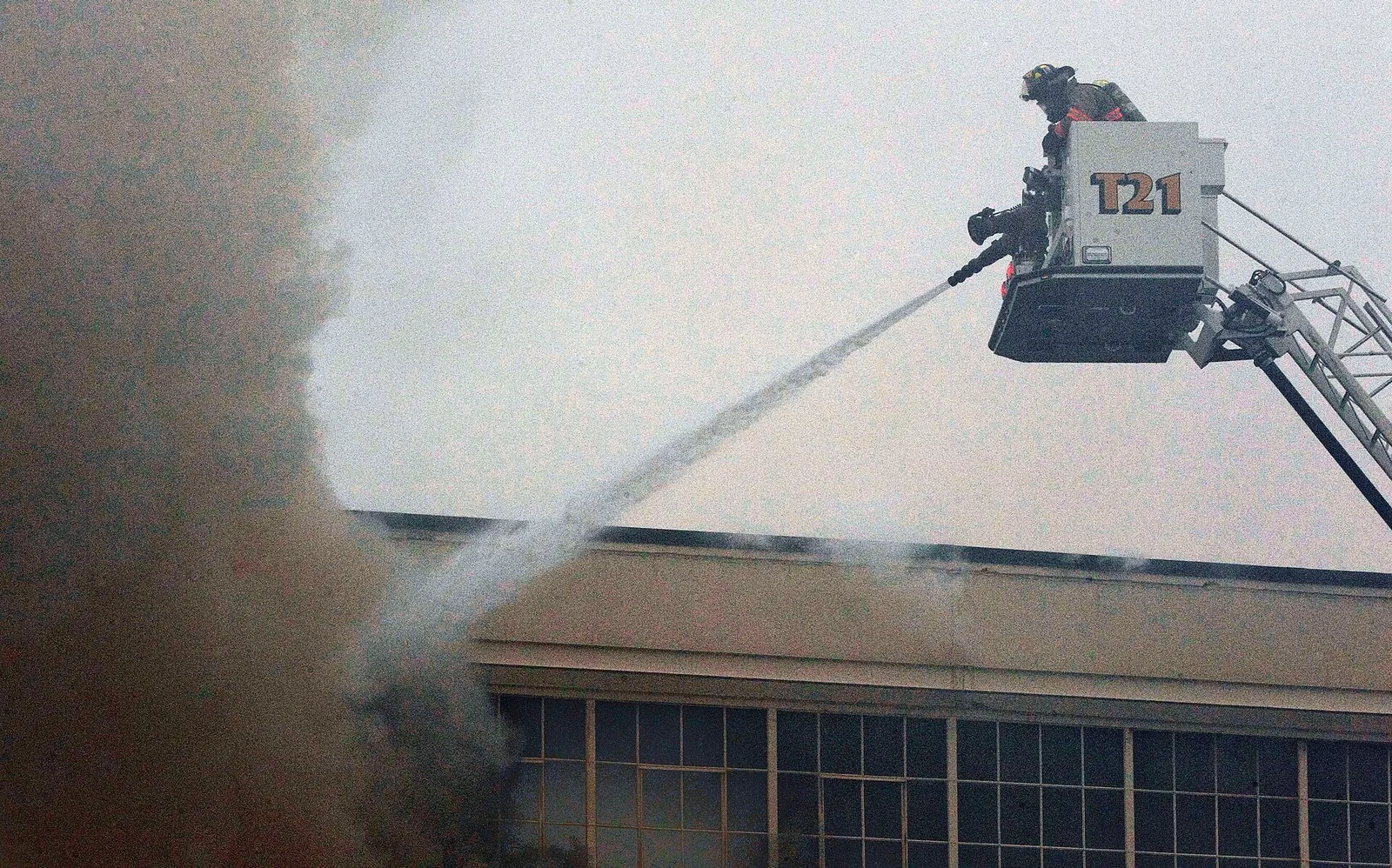 Firefighters work to put out a warehouse fire.