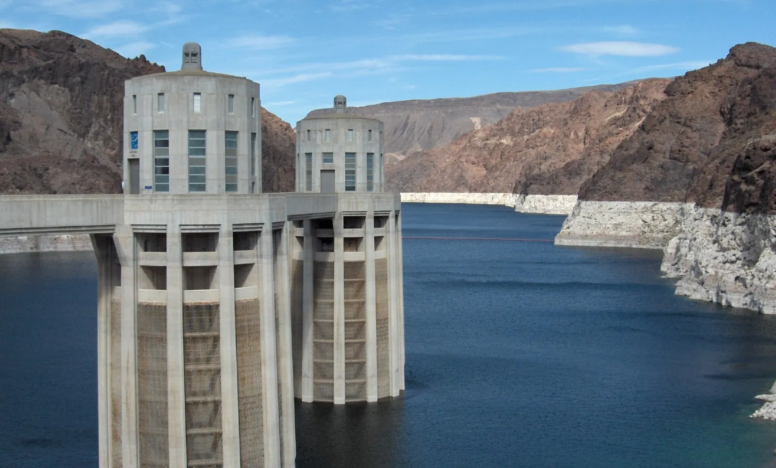 Intake towers at Hoover Dam showing the exposed mineral line above Lake Mead's water level