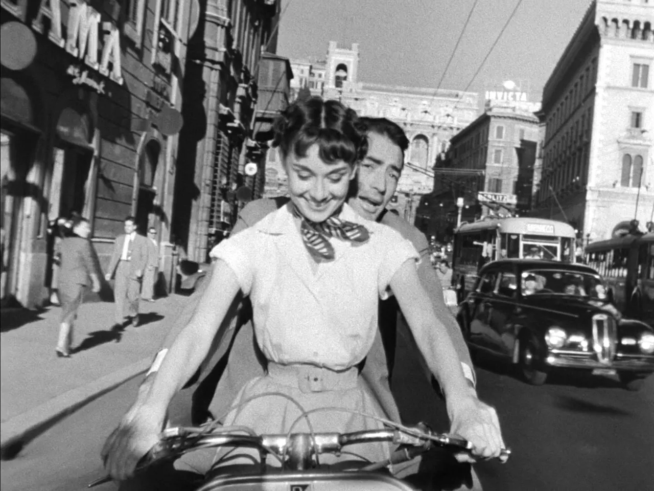 Audrey Hepburn and Gregory Peck on a Vespa in a still from the 'Roman Holiday' trailer (1953).