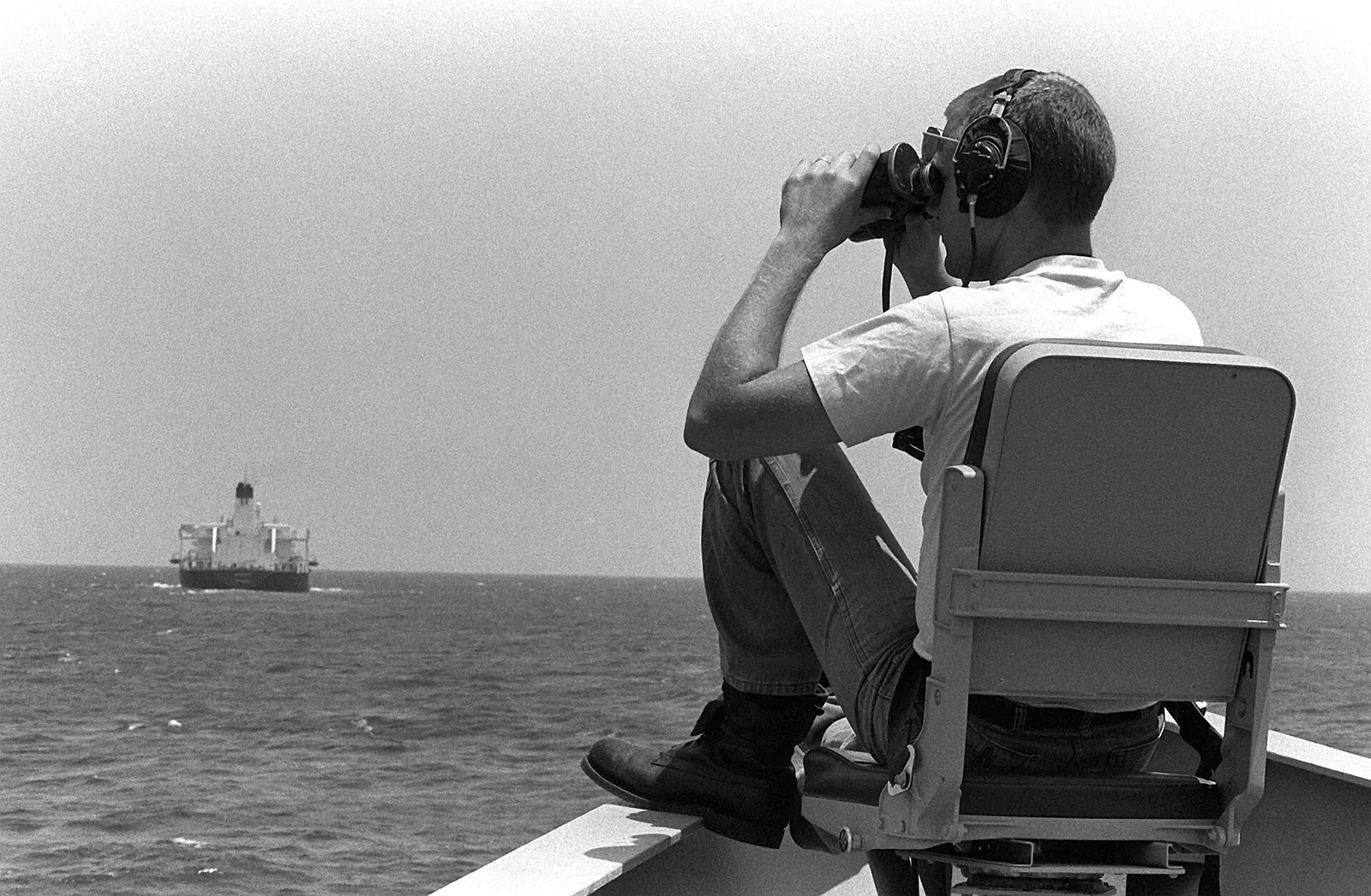 A U.S. Navy warship escorts a tanker in the Persian Gulf