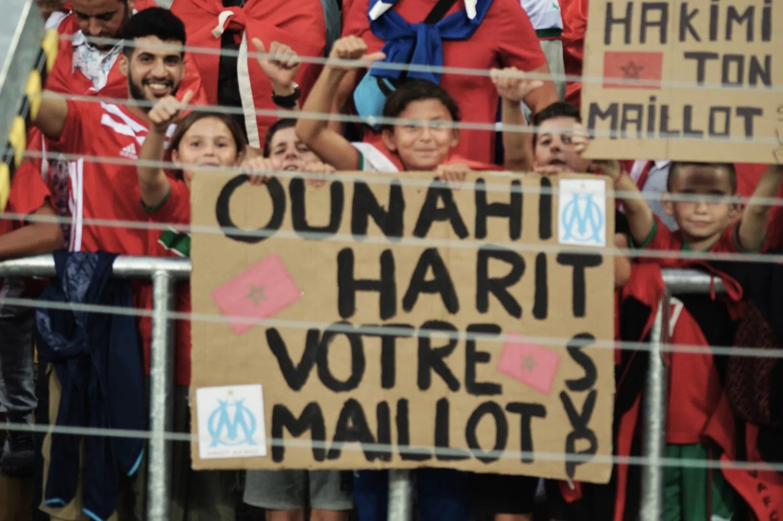 Morocco supporters waving flags at a football match.
