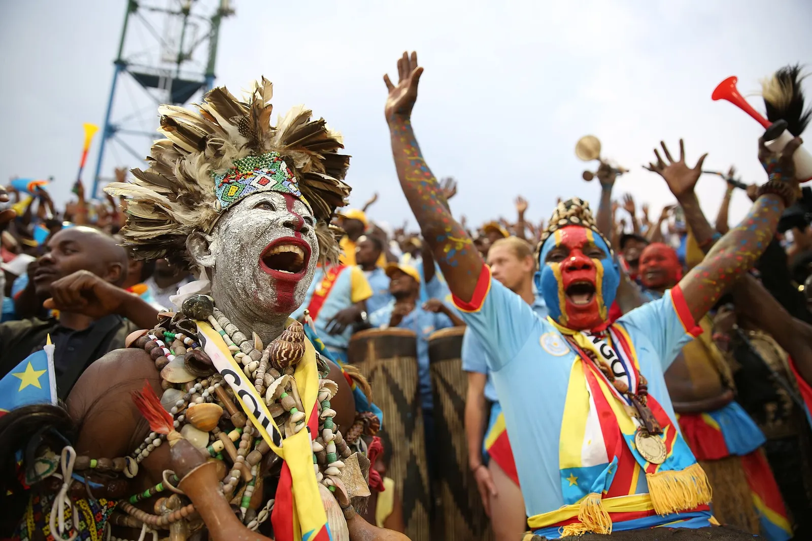 Congolese football supporters celebrate in the stands.