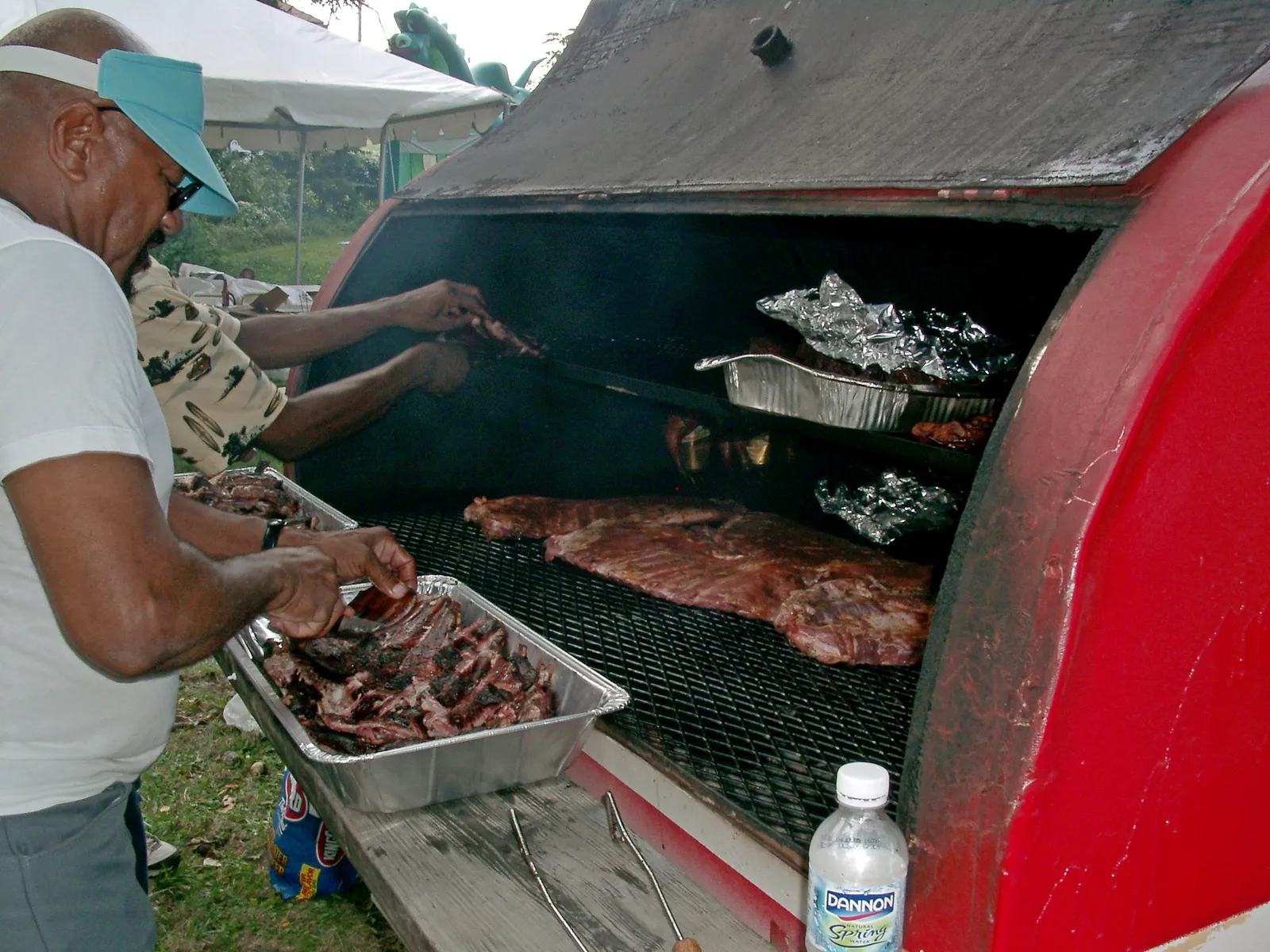 Food grilling at a summer barbecue block party.