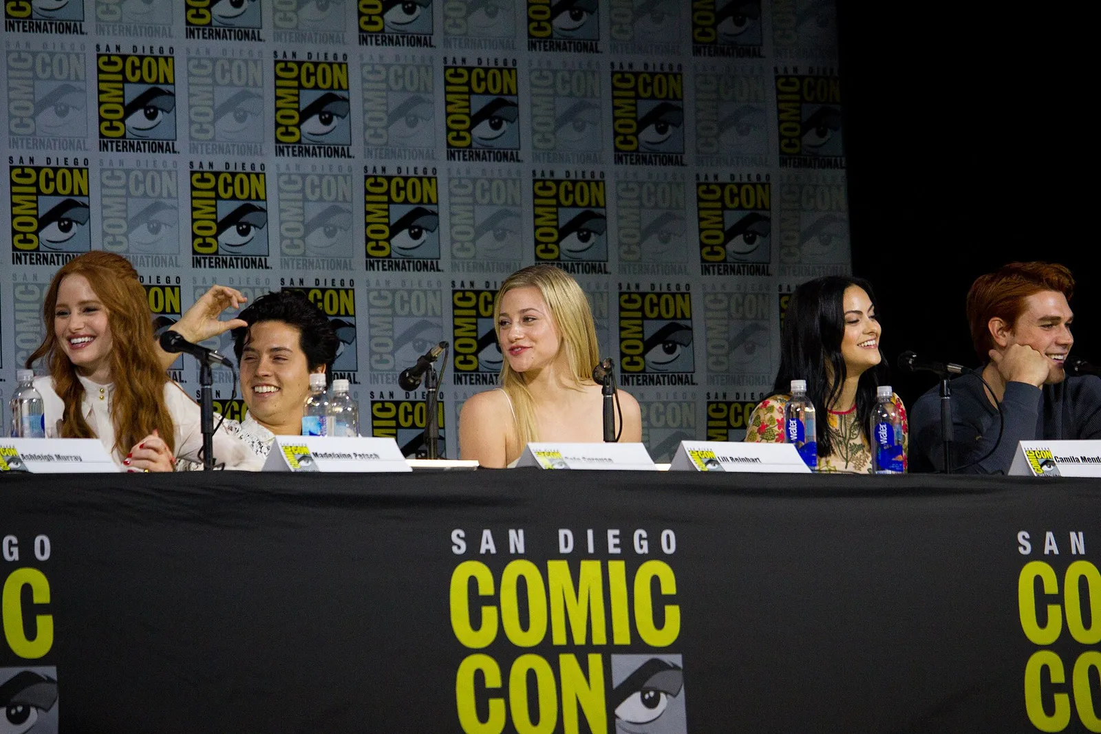Lili Reinhart with castmates at a Comic-Con panel.