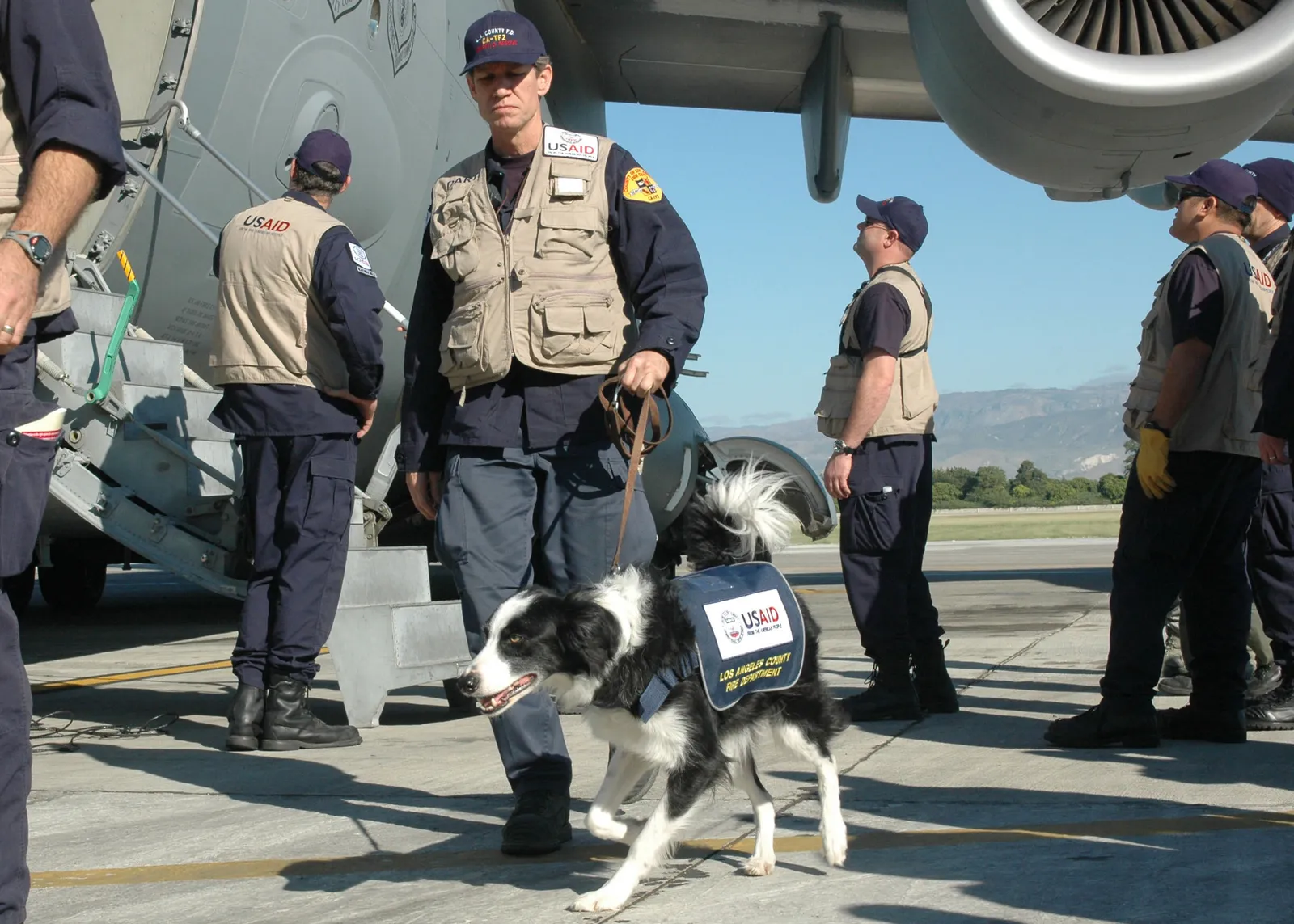 U.S. airmen loading an urban search-and-rescue team and equipment onto an aircraft.
