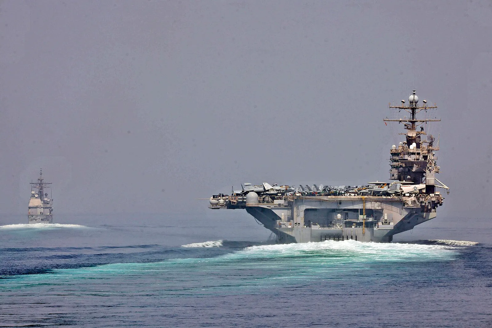 US Navy ships transit the Strait of Hormuz.