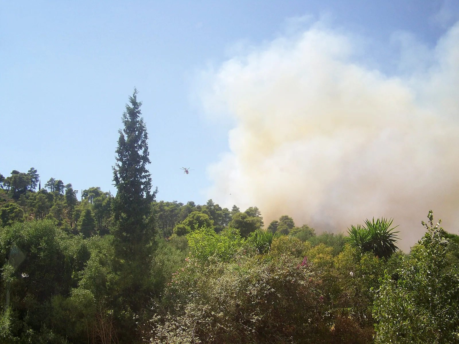 A Greek firefighting helicopter working over a wildfire