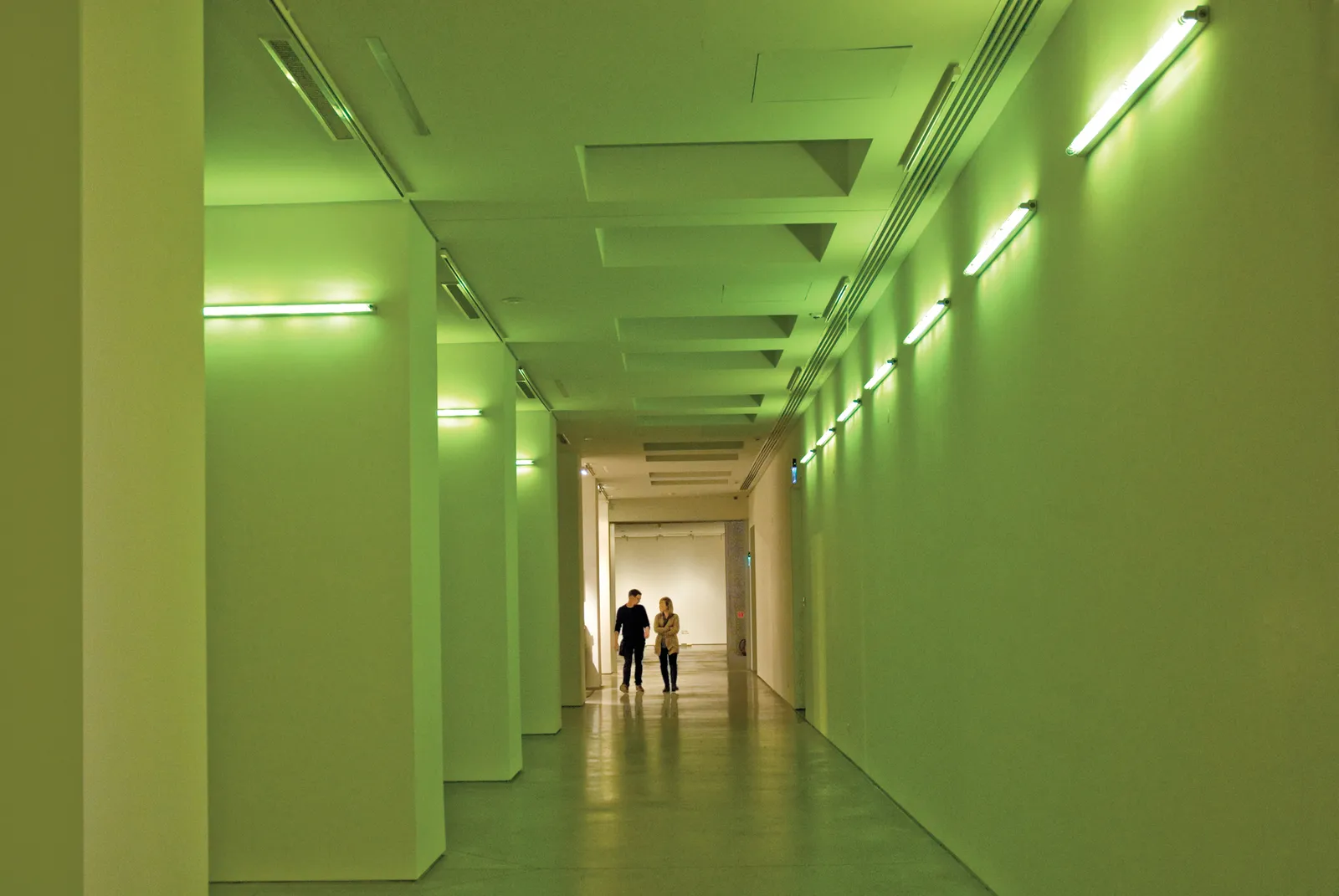 A neon light art installation in a gallery.