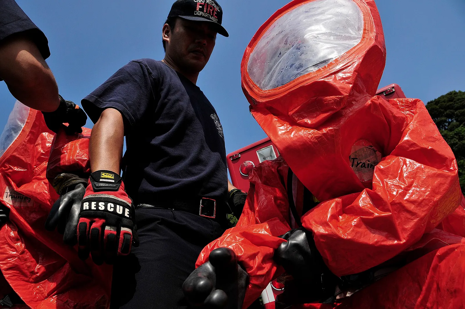 Firefighters in protective suits prepare to respond to a chemical spill.