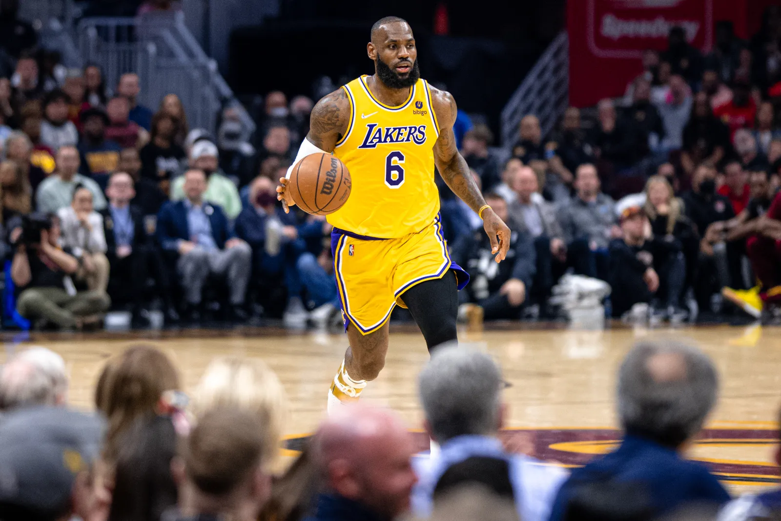LeBron James dribbling in a Lakers uniform.