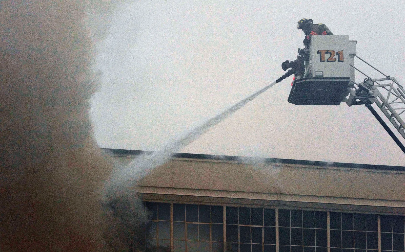 Firefighters work to put out a warehouse fire.