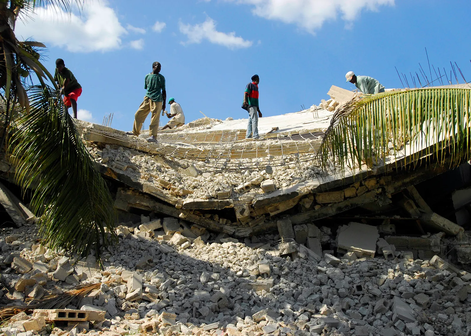 Residents clear rubble after an earthquake.