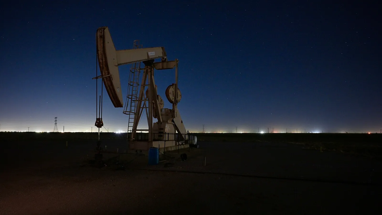 An oil pumpjack in a field.