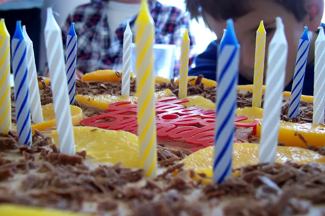 A birthday cake with lit candles.