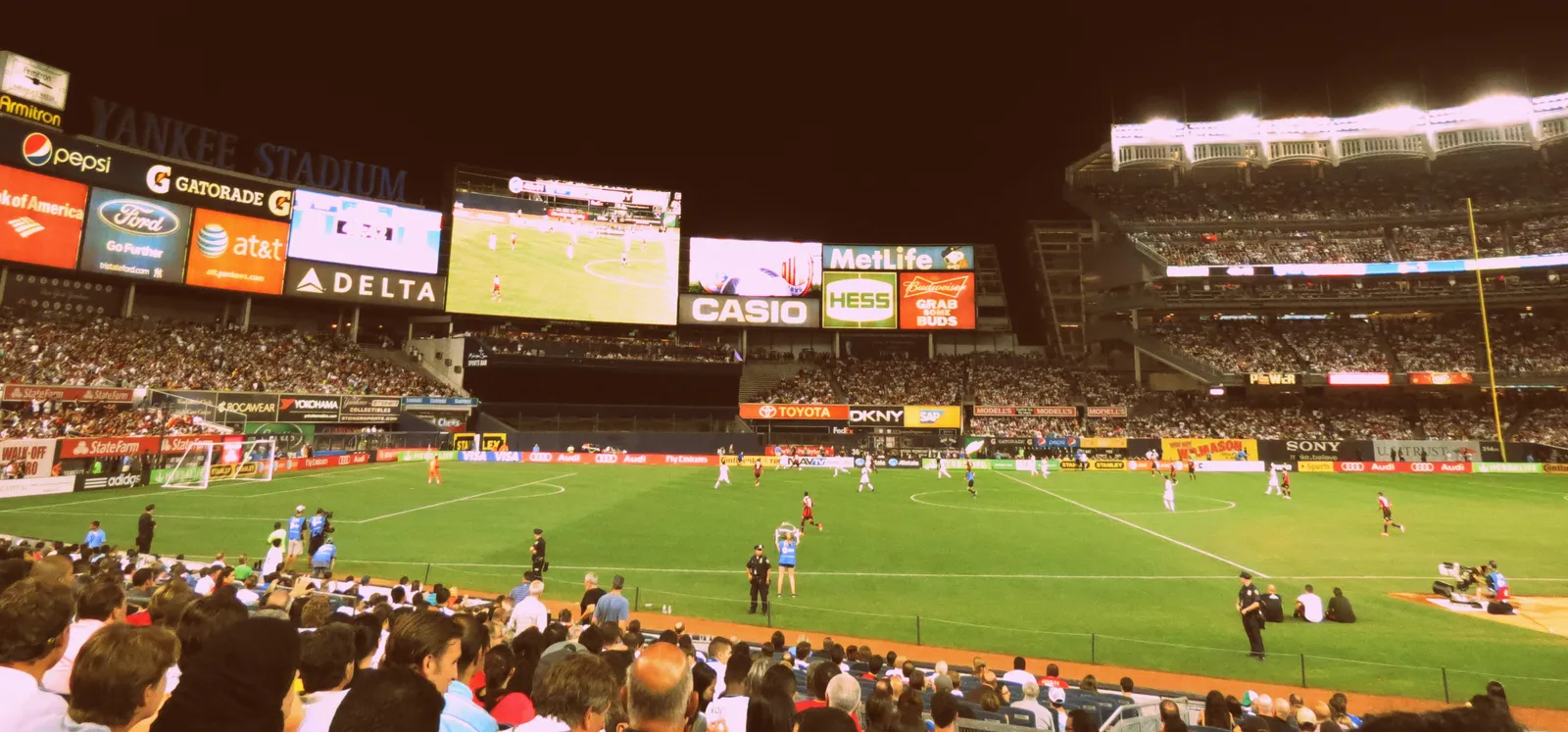 A soccer match in a packed stadium.