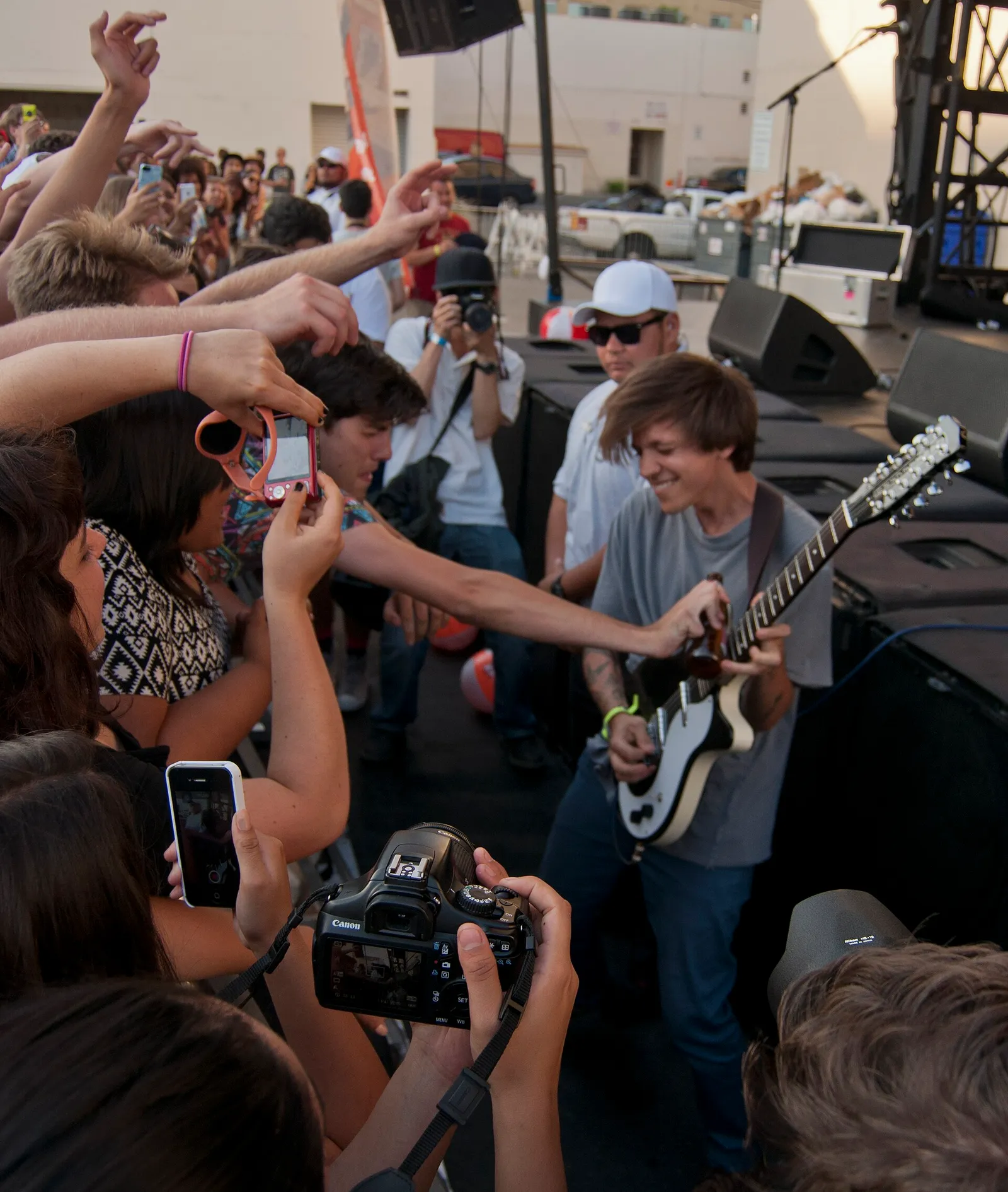 A guitarist performs at an outdoor music event